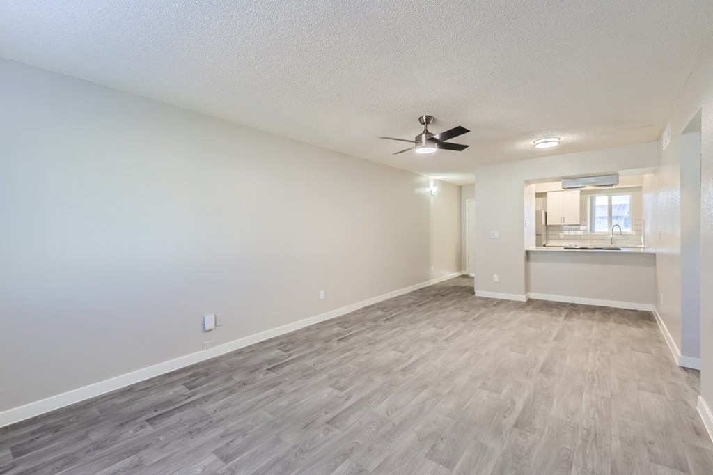 A room with a ceiling fan and light fixture.