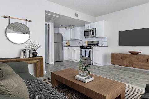 A modern living room with a grey sofa and a wooden coffee table.