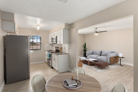 A modern kitchen with a dining table and chairs.