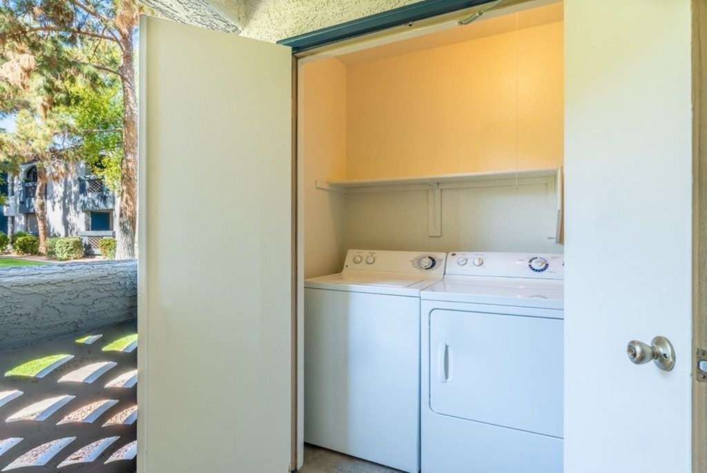A small laundry room with a washer and dryer.