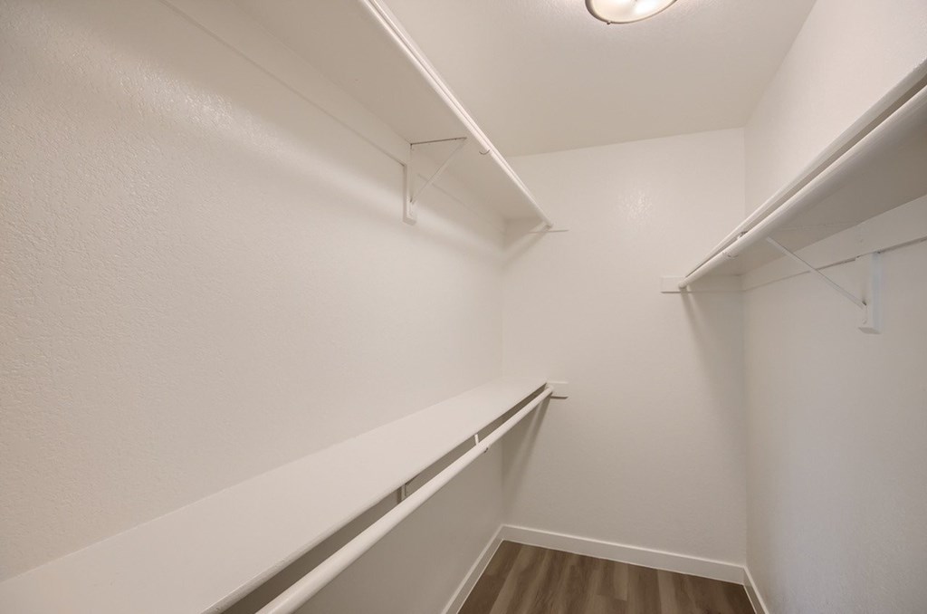 A white hallway with a light on the ceiling.