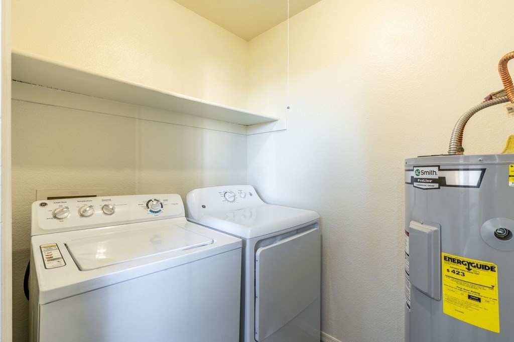 A small laundry room with a washer and dryer.