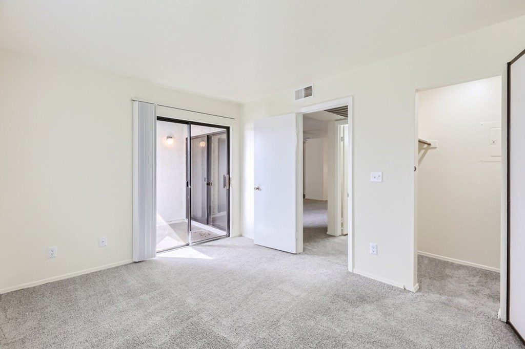 A room with a carpeted floor and white walls.