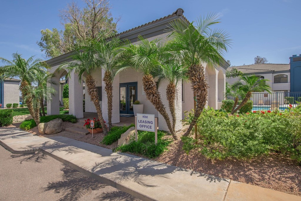 A building with a sign that says "Leasing Office" in front of it.