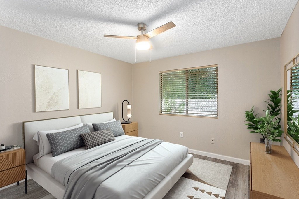 A bedroom with a bed, nightstand, and two pictures on the wall.