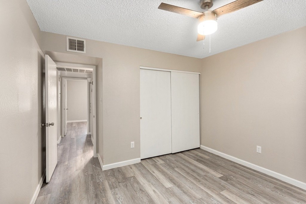 A room with a white door and a white closet.