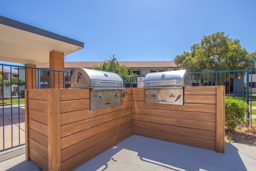 A wooden fence with two mailboxes on it.