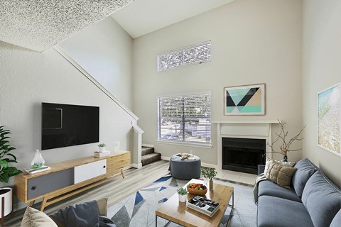 A living room with a grey couch and a coffee table.