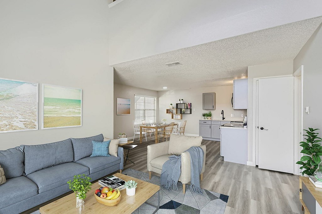 A living room with a grey couch and a wooden coffee table.