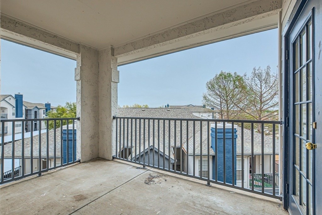 A balcony with a view of a residential area.