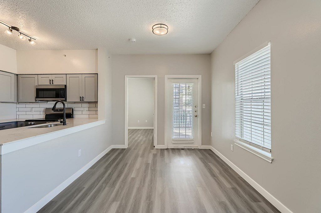 A kitchen with a microwave, oven, and a countertop.