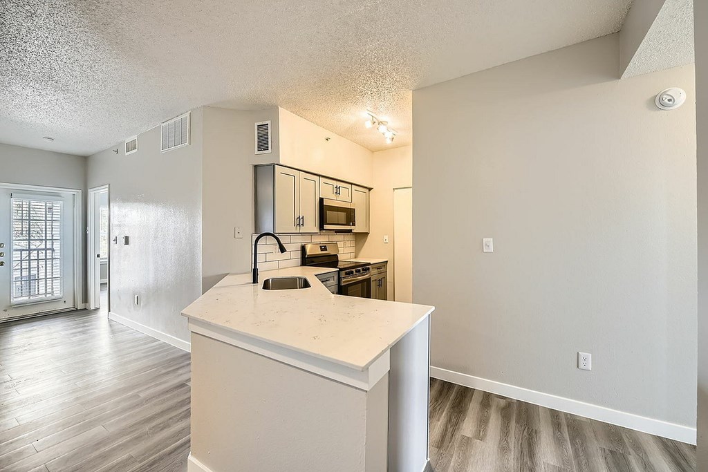 A kitchen with a sink and a counter.