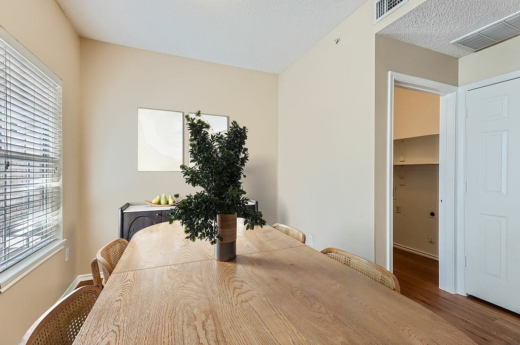 A room with a white door and wooden flooring.
