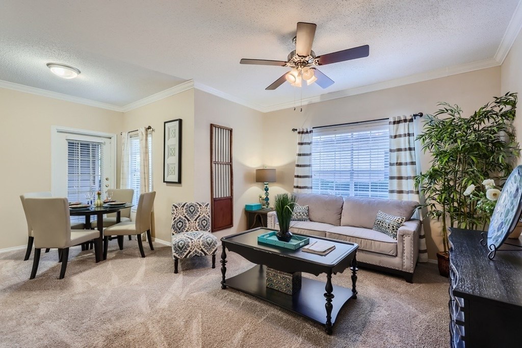 A living room with a dining table and chairs.