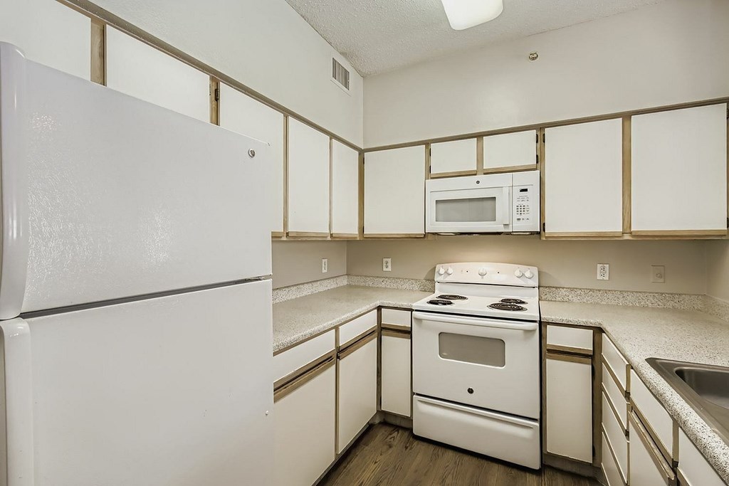 A swimming pool in a residential area with a building in the background.