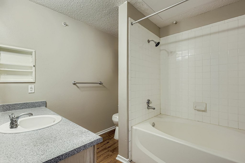 A white bathroom with a sink, toilet, and bathtub.