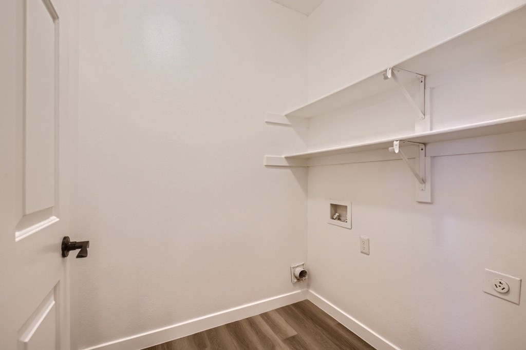 A white door with a black handle is on the left side of the image.