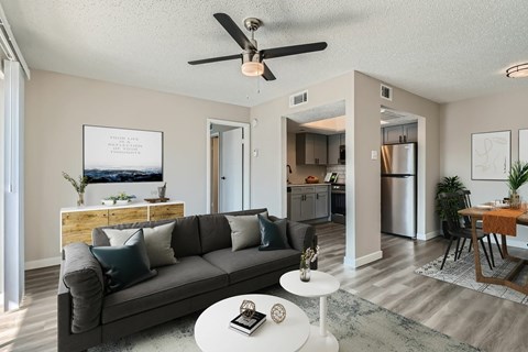 A living room with a grey couch and a white coffee table.