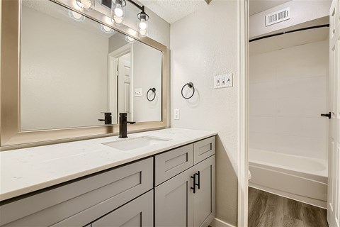A spacious room with a ceiling fan and carpeted floor.