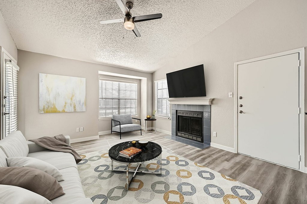 A living room with a fireplace and a television.