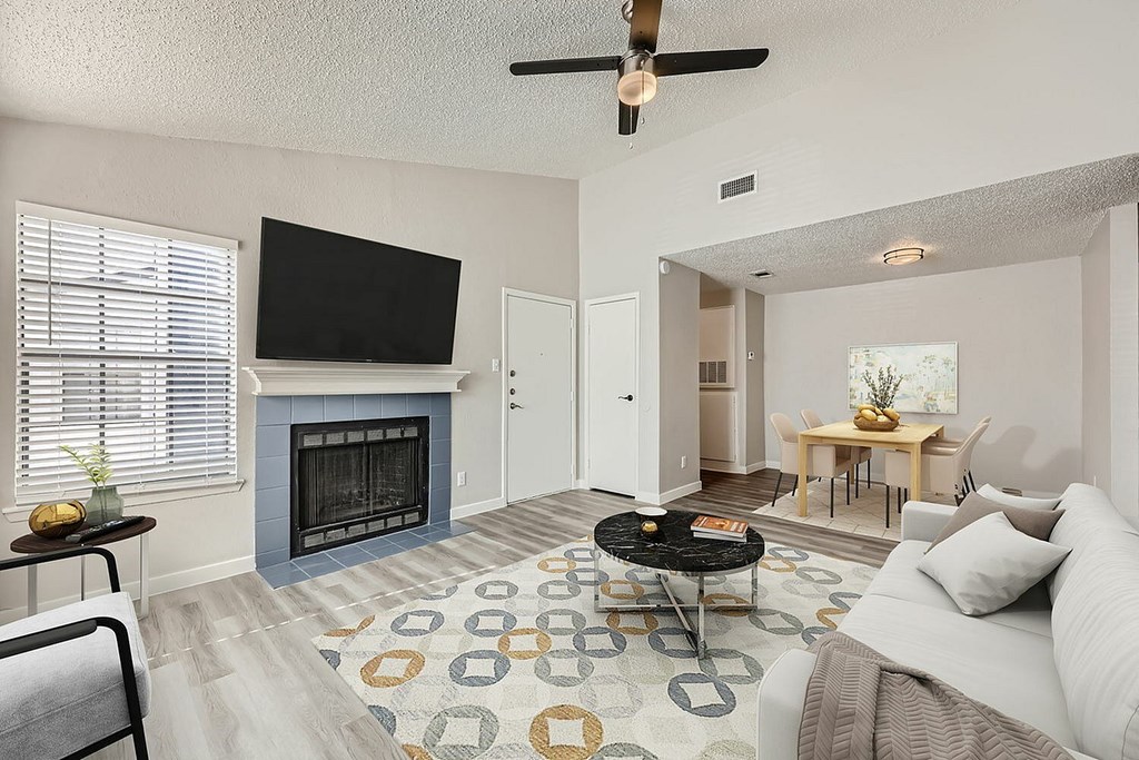 A living room with a fireplace and a television.