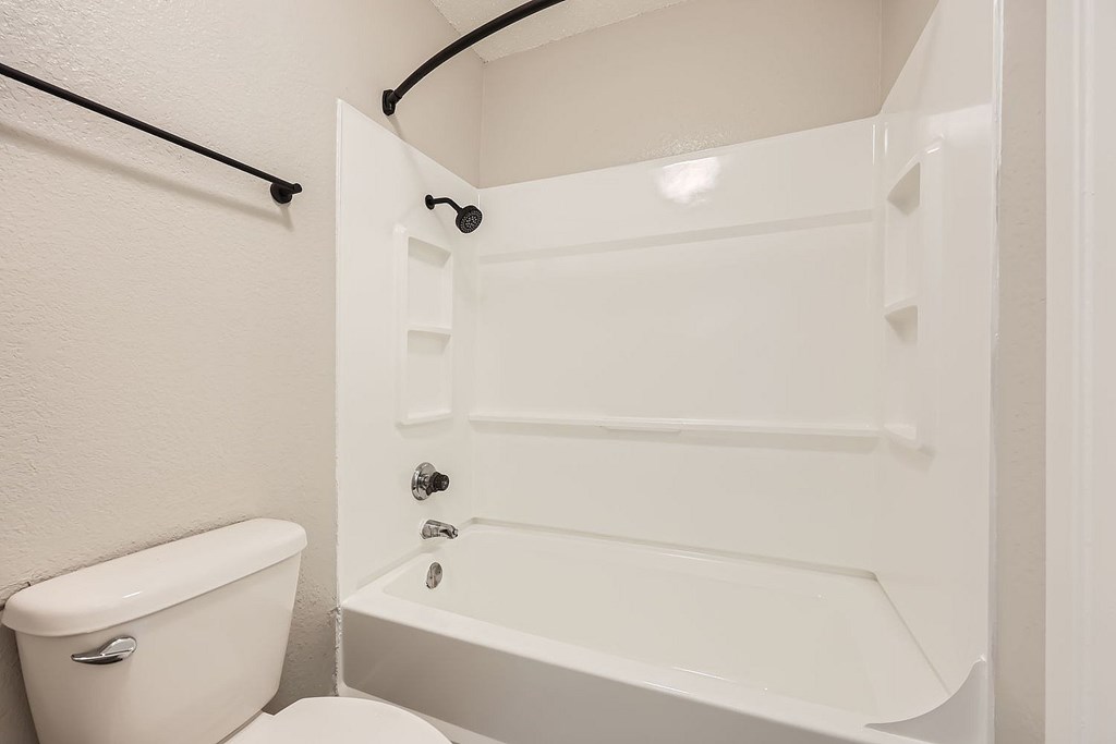 A white toilet and sink in a small bathroom.