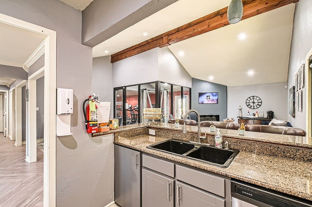 A kitchen with granite countertops and stainless steel appliances.