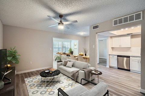 A living room with a grey couch and a black coffee table.