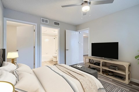 A bedroom with a large bed and a television.