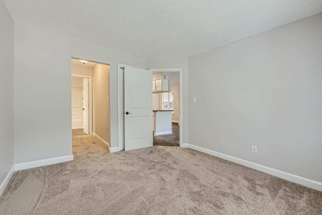 A room with a carpeted floor and white walls.