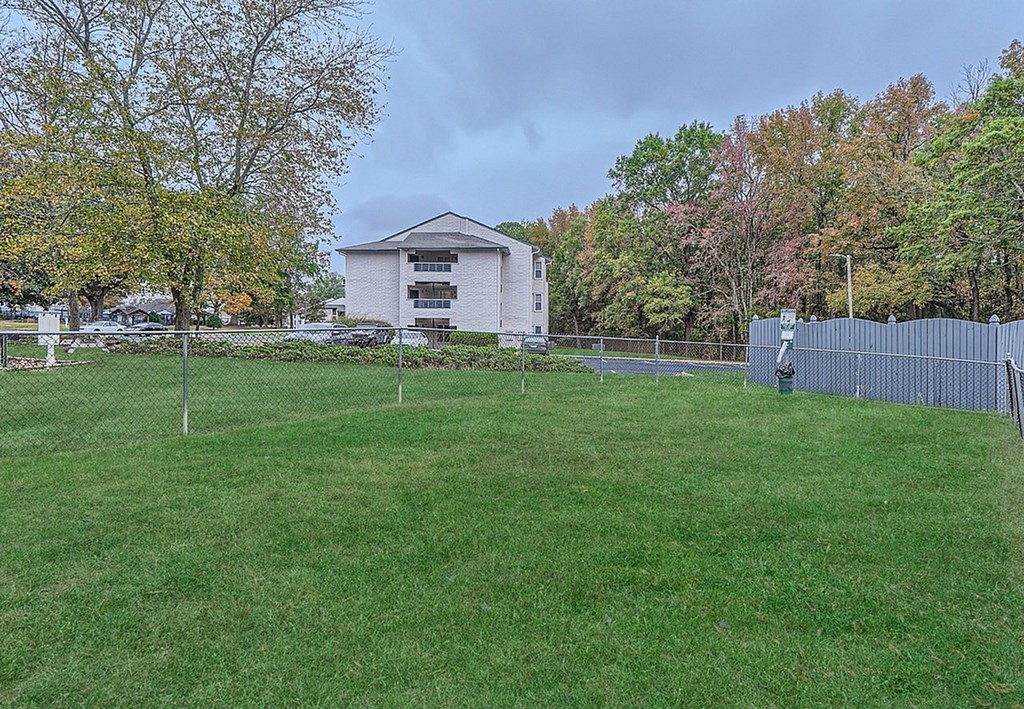 A grassy field with a building in the background.