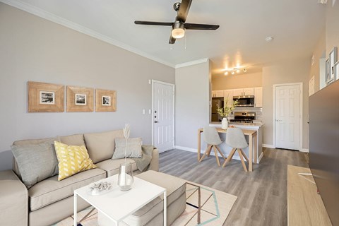 A living room with a grey couch and a white coffee table.