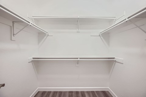 Empty white shelves in a room.