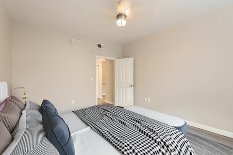 A bedroom with a bed and a couch.