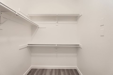 Empty white shelves in a room.