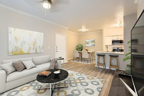 A living room with a white couch and a black coffee table.