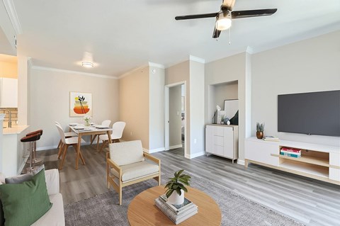 A living room with a dining table and chairs.