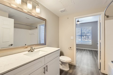 A bathroom with a white sink and a white toilet.