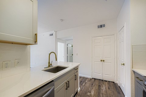 A modern kitchen with a dining table and chairs.