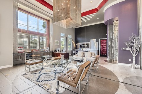 A modern living room with a glass table and chairs.