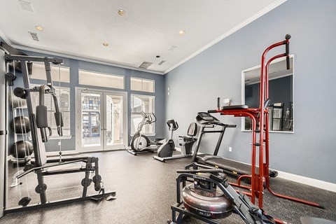 A spacious home gym with a variety of equipment.