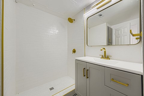 A room with a bench and a window.