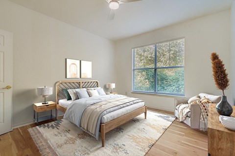 A wooden pergola is over a table in a courtyard.