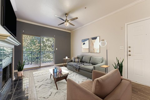 A living room with a grey couch and a coffee table.