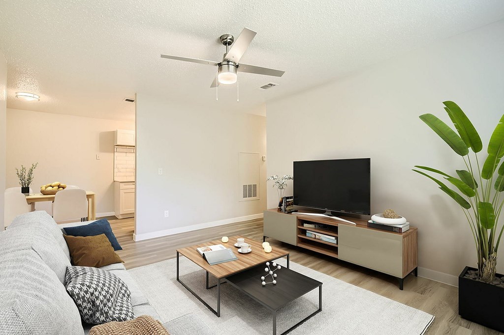 A living room with a grey couch and a black coffee table.
