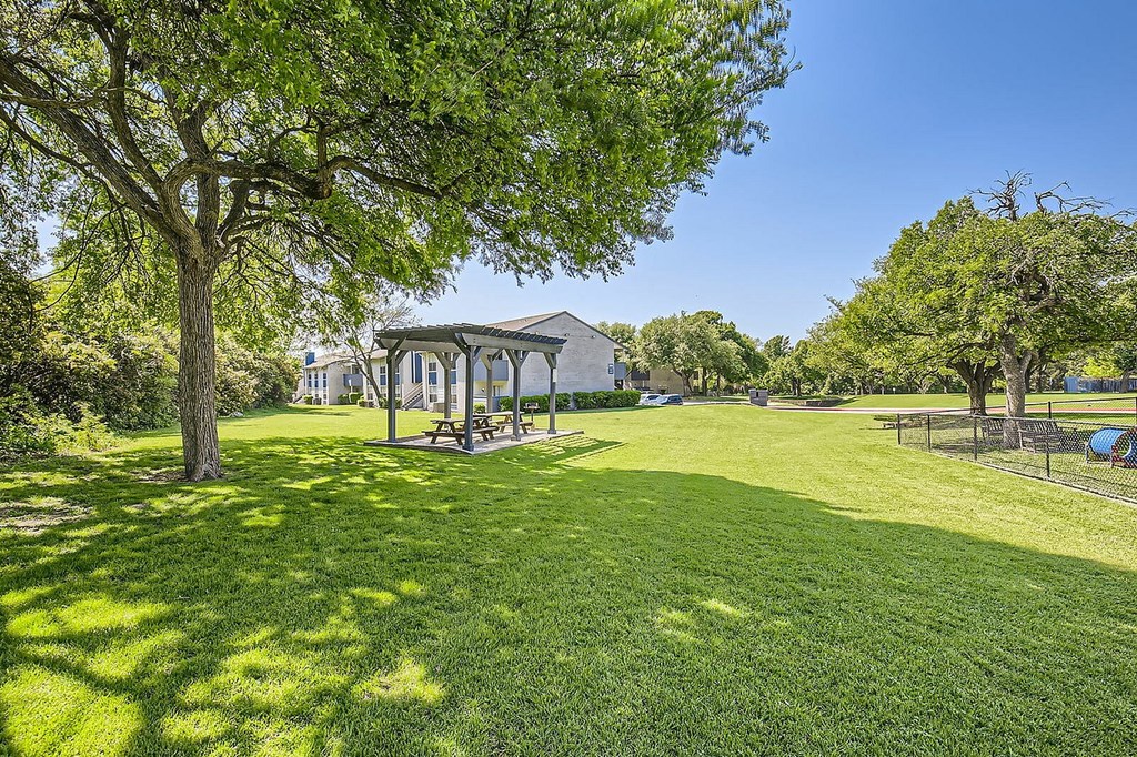 A park with a gazebo and a picnic table.