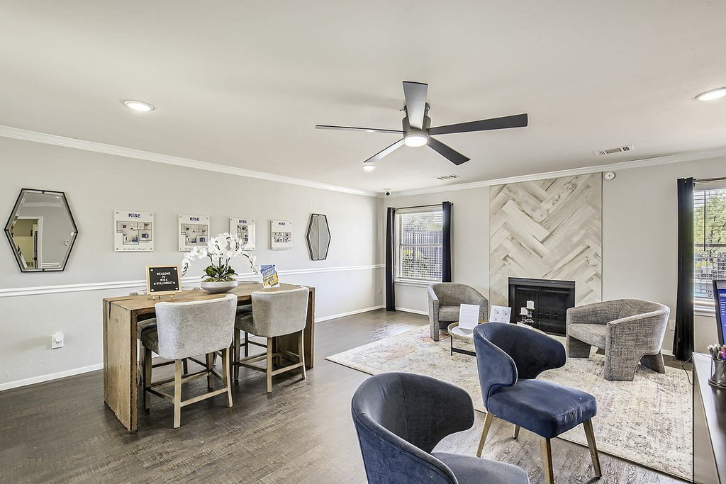 A living room with a fireplace and a dining table.