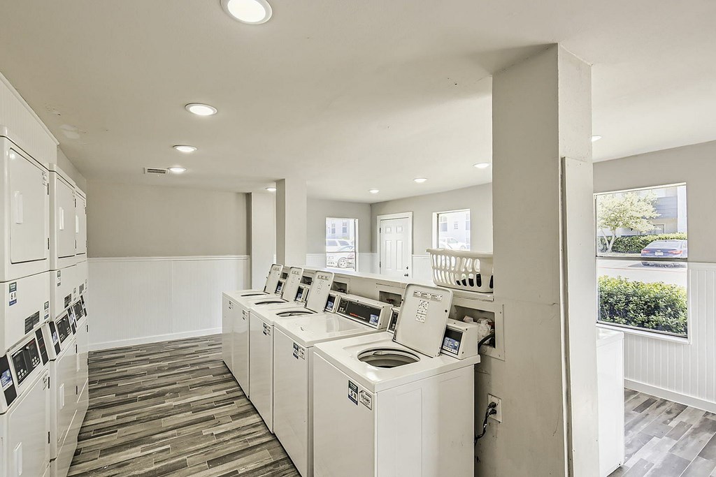 A laundry room with washers and dryers.