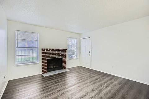 A room with a fireplace and a window.