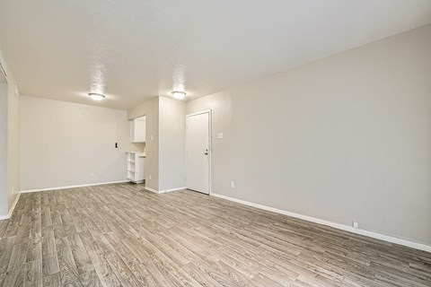 A room with a wooden floor and white walls.